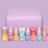 A collection of haircare products in travel sizes displayed in front of a purple bag with the text 'Mark Hill'.