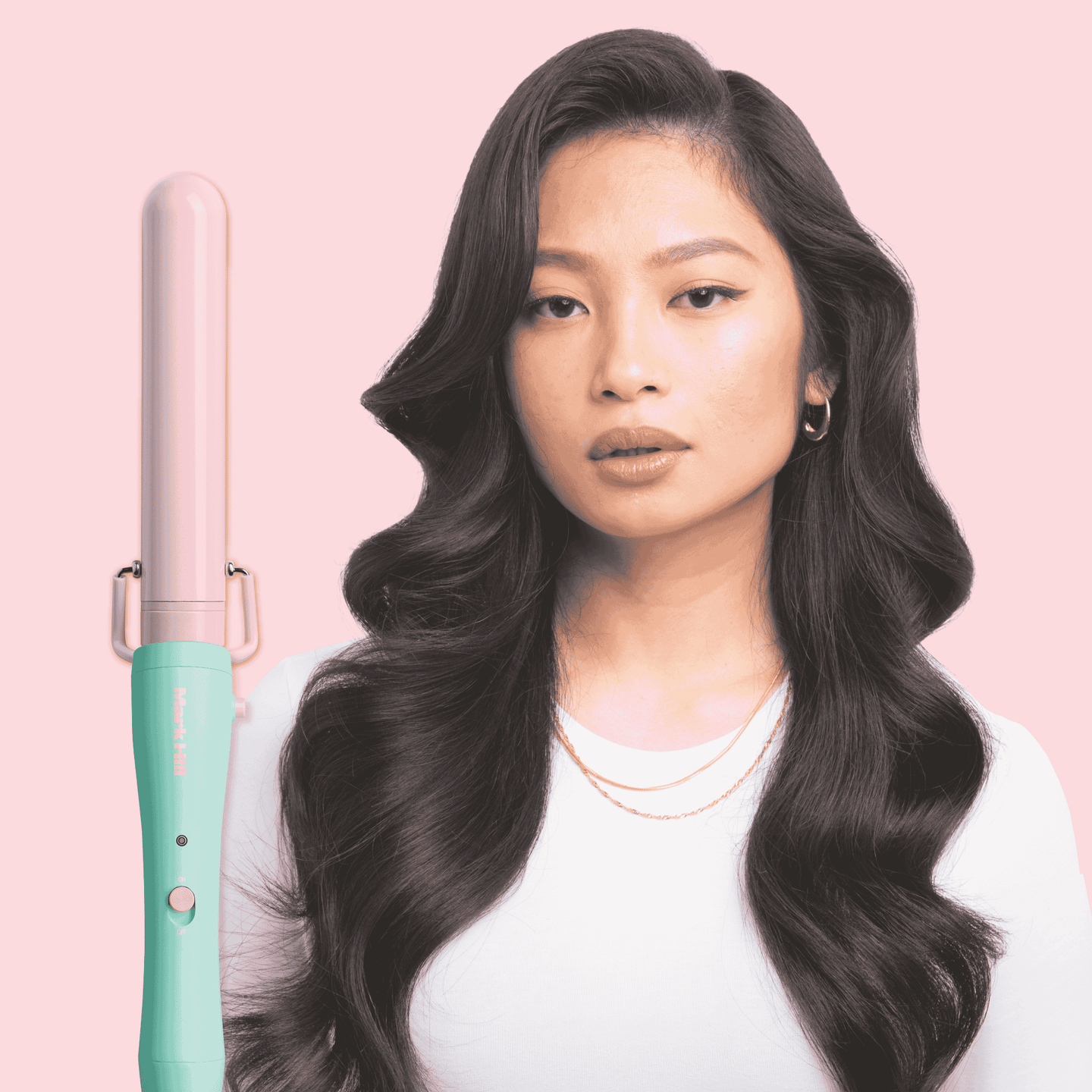 Woman with styled hair holding a teal and pink hair straightener against a pink background