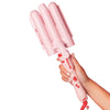 A hand holding a pink curling wand with a cherry design on a white background.