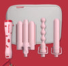 A collection of hair curlers with a red handle and various sized barrels displayed in front of a light blue bag with a cherry print mark hill
