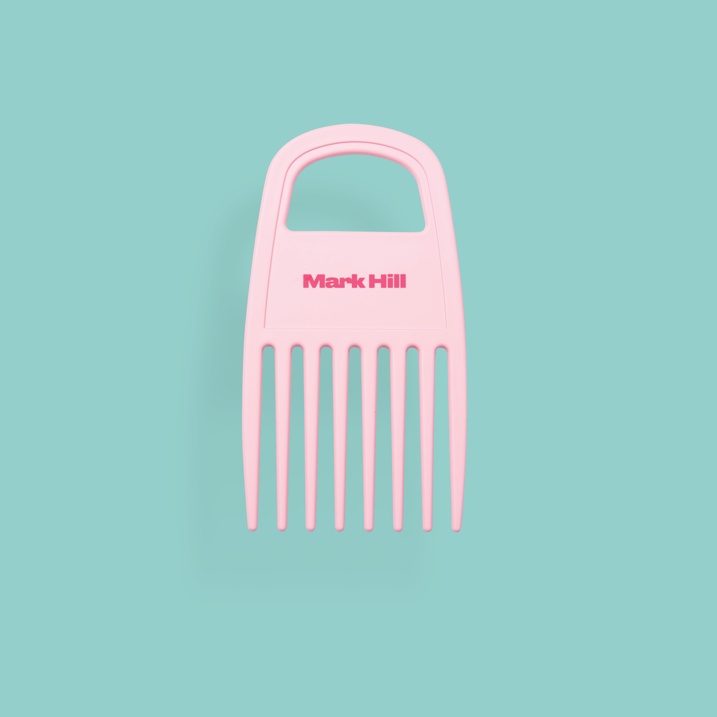 A pink curl comb with wide teeth, designed for brushes and combs, with the brand name 'Mark Hill' on the top.